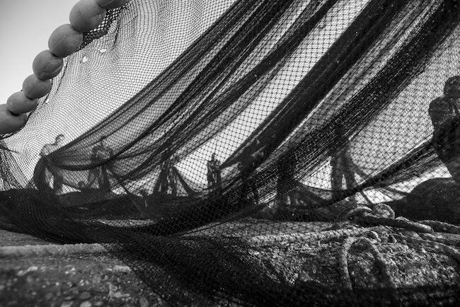 Fishing nets and floats being hauled on deck