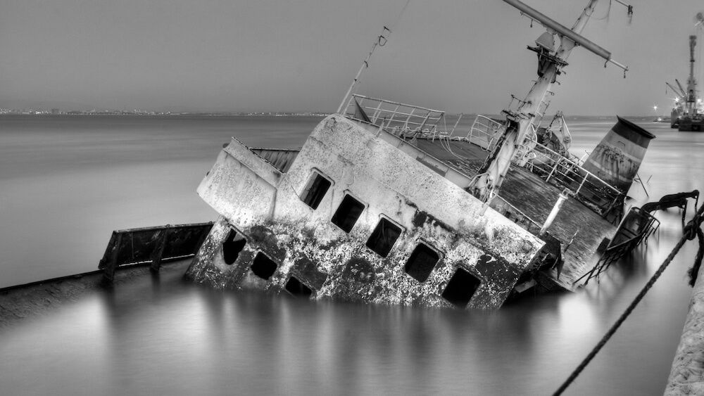 Wreck of a capsized ship lying in the water